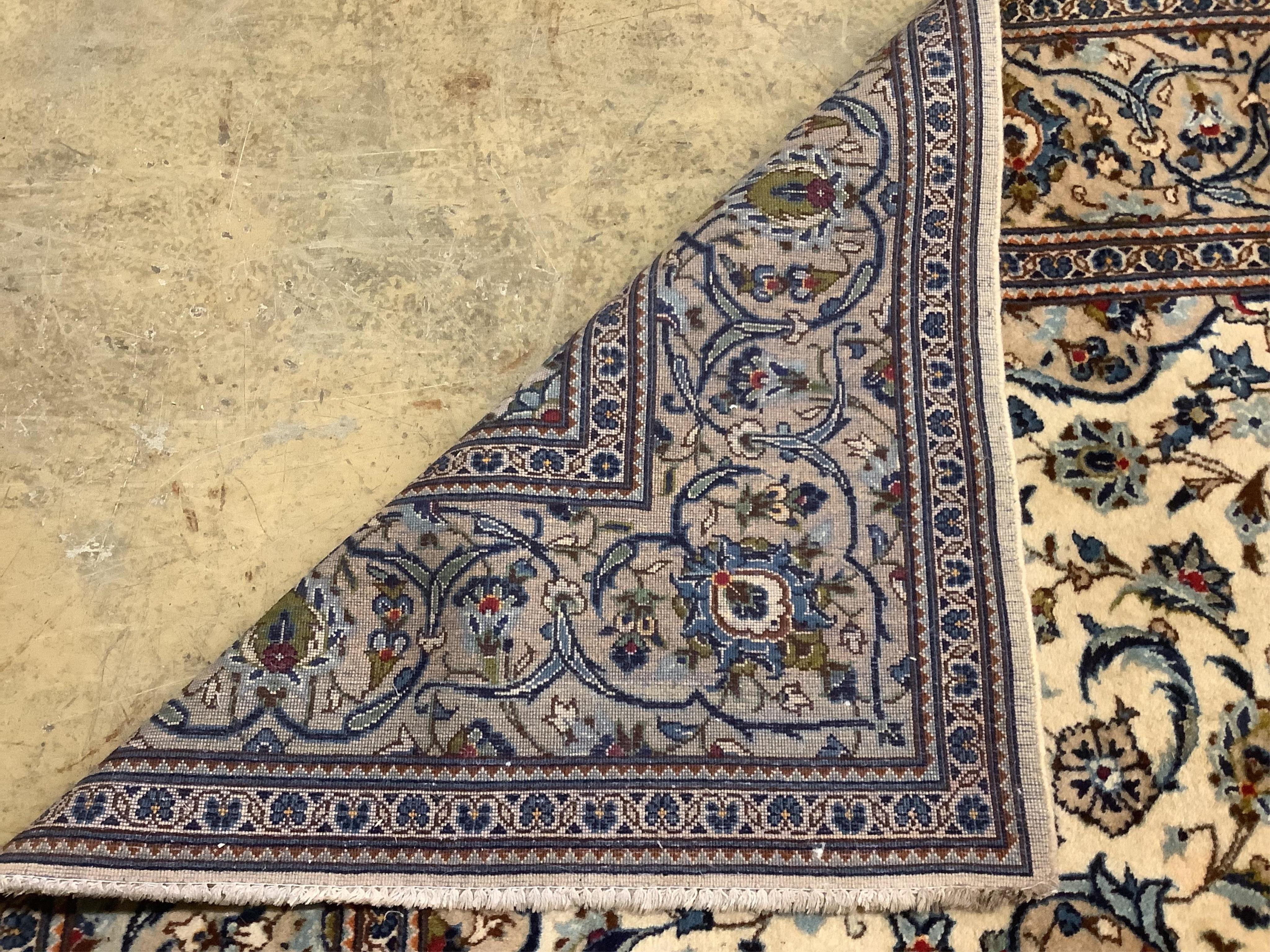 A Tabriz ivory ground carpet, 294 x 198cm. Condition - fair